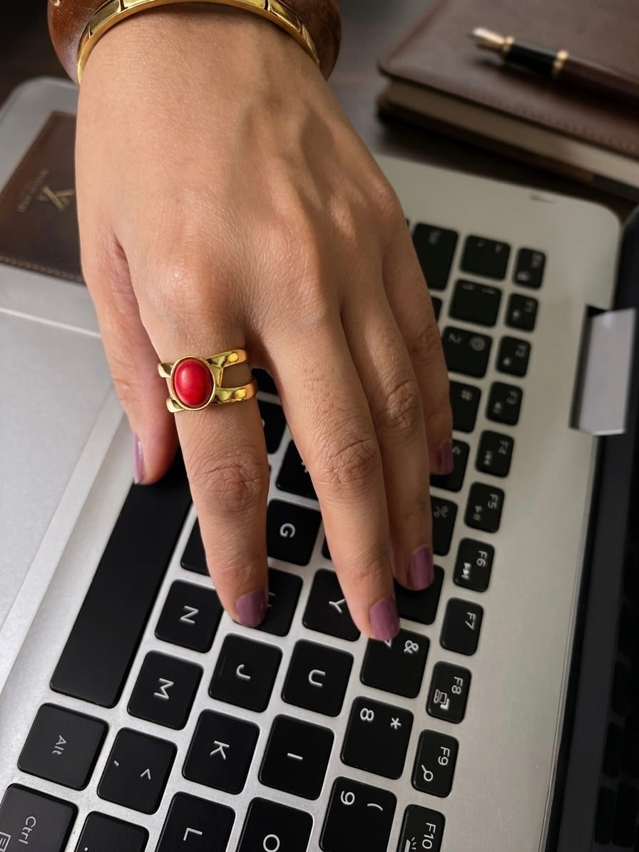Gold plated double band oval red coral cabochon ring on woman's hand, bold red gemstone statement jewelry