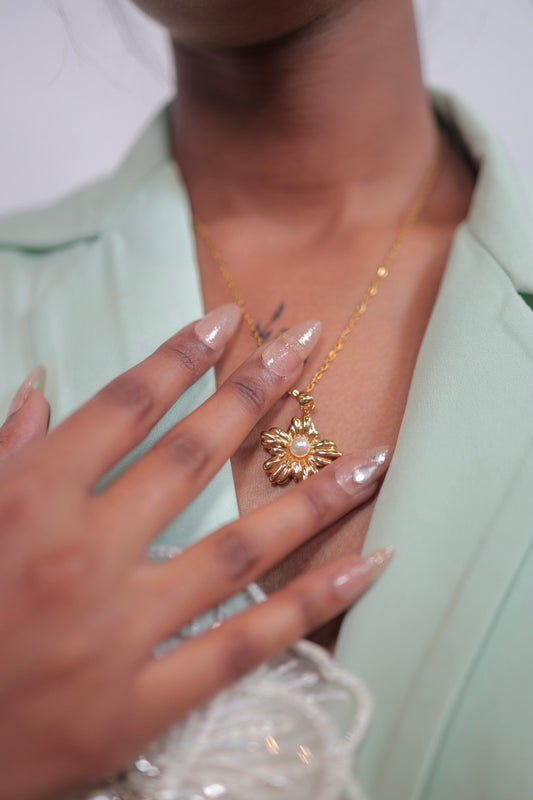 Gold plated anti-tarnish flower pearl chain  with pearl center bloom and delicate gold chain draped across hand.