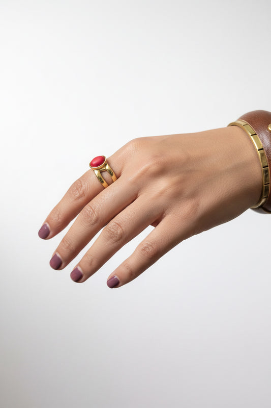 Gold double band oval red coral cabochon ring on woman's hand, bold red gemstone statement jewelry